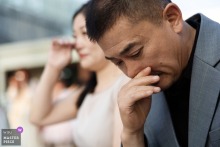 At Banyan Tree On The Bund, Shanghai, the groom’s father looks emotional while his mother wipes tears during the heartfelt wedding ceremony.