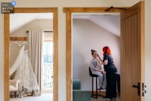 At Hobbit Hill, Lancashire, the bride prepares for her wedding in a cozy room beside her hanging white wedding dress.