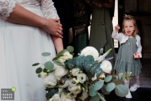   A little girl at the wedding in Macon looks on with jealousy, her expression capturing the innocence and candid emotions found among young guests.