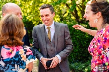   Guests share hearty laughter and warm camaraderie with friends during festivities at Clock Barn in Hampshire, England.