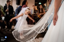 In The Gasfabriek, Alkmaar, during a speech, a little bridesmaid with a mini-veil playfully drops the bride's veil.