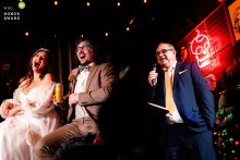 A clever mirror reflection captures the authentic reactions of the couple and guests during the father’s speech at Amsterdam Brewery in Toronto, showcasing a unique and artistic perspective.