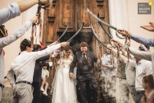 In Bergamo, Lombardy, Italy, newlyweds exit the church and walk through a gauntlet of swords held by friends, a nod to their wedding's "pirates" theme. The winning photograph highlights the photographer's skill at capturing unique, unscripted moments.