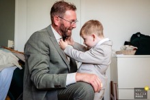 Young Boy Fixes Man’s Tie At Home In 's-Hertogenbosch Noord Brabant - Tender Preparation Moment At home in 's-Hertogenbosch, Noord Brabant, the photographer captures a young boy carefully fixing a man’s tie, expertly preserving a tender, behind-the-scenes moment of preparation and connection.