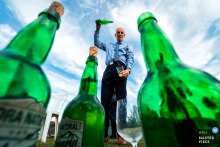 At Domaine Etxezahar in Bardos, France, the photographer captures the Spanish cider-serving tradition, using a low angle to highlight green glass bottles, showcasing cultural vibrancy and creative visual perspective.