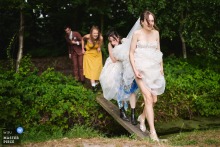 Bride on a plank crossing water in a park in Amsterdam, Noord Holland.