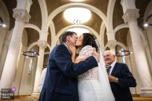 Bride kisses father outside Église Notre-Dame du Bon Secours, Lyon, France.
