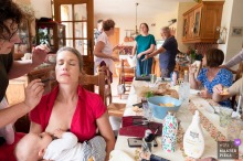 In Oise, Hauts-de-France, the photographer captures an intimate, powerful scene as the bride breastfeeds while having her makeup done at home, expertly highlighting maternal devotion and multifaceted wedding preparations.