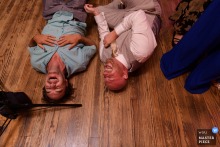 At Kitty Hawk Pier, a WPJA-winning photo showcases friends collapsing in laughter on the dance floor, demonstrating the photographer’s keen eye for capturing genuine, joyful moments.