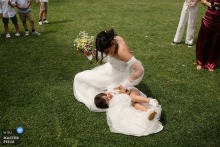 A touching WPJA contest image from a Lisbon reception captures the bride’s daughter in awe of her mother’s wedding dress, highlighting the photographer’s moment-capturing and storytelling abilities.