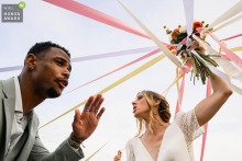 Participants engage in a vibrant bouquet ribbon game during a celebration at Maison de Lacan, showcasing a unique and playful cultural tradition within the beautiful venue in Toulouse, France.