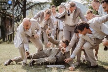 At Vecchia Borgata I Muri, a wedding venue in Piedmont, the groom and friends race to drink a beer, creating a rowdy and raucous scene during the celebration.