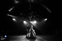 At Guinguette des Javanaises in Loches, France, the newlyweds share their first dance under the intimate glow of a circus tent, surrounded by warm, festive ambiance.