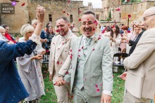 Château Grange Fort, Puy de Dôme Wedding: Laughter And Red Petals For Newlyweds At Château Grange Fort in Puy de Dôme, a joyful burst of laughter and red petals surrounds the newlyweds as they celebrate their union after saying “yes.”
