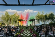 Against the stunning backdrop of the Amalfi Coast, a couple shares their first kiss at Villa Eva in Ravello as vibrant, colorful smoke cannons erupt into the sky.