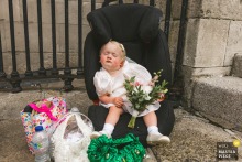 At Dublin City Hall, the flower girl naps in her car seat clutching her bouquet, moments before heading down the aisle for the wedding ceremony.