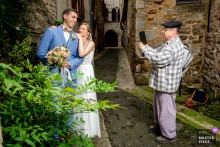 In Saint-Antonin Noble Val, Tarn-et-Garonne, the newlyweds are photographed by a passerby, capturing them in the heart of the town.