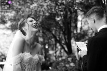 In Chicago, a black-and-white photo captures candid emotions beneath the trees as the couple exchanges their vows, highlighting intimacy, authenticity, and the natural beauty of their outdoor ceremony.