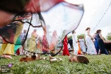 In Inharria, Saint-Pée-sur-Nivelle, guests dance barefoot on the grass, twirling their dresses with joyful abandon. A low-angle shot from ground level captures the playful movement and carefree spirit under flowing skirts.