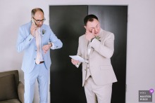   During a heartfelt moment at Mercure Hotel in Krefeld, Germany, a groomsman answers a phone call while the groom weeps, reading a touching letter from his wife.