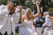   Laughter and surprise erupt at Schloss Gimborn in Marienheide, Germany as the bride and groom are joyfully attacked with rice by their guests after the ceremony.