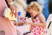 A child at the Noord Holland marriage location is lovingly fed a piece of wedding cake, savoring the sweet treat while surrounded by celebration and laughter.