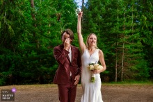 Joy Overflows At Beyond Hope Resort, Idaho, As The Bride And Groom Celebrate Outdoors, Surrounded By Love And Excitement. Emotions run high at Beyond Hope Resort in Idaho, where the bride and groom celebrate joyfully, filled with excitement and love immediately following their outdoor wedding ceremony.