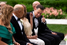 During the outside ceremony at The Mount in Lenox, Massachusetts, a guest offers a thumbs up to the groom’s parents as they take their seats, sharing encouragement and excitement for the special day.