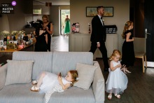  Bridal preparations at Thornhill Hotel in Hampshire, UK, are a mix of chaos and calm, with several flower girls occupying themselves in unique and entertaining ways in the busy room.