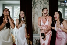   Champagne corks fly at Hotel Particulier Montmartre in Paris, sparking amusing and surprised reactions from guests as they celebrate in this French venue.