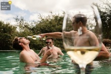   At home in Lisbon, Portugal, the groom and his friends relax in the pool with drinks, taking a break from the celebrations and enjoying a moment of camaraderie together.