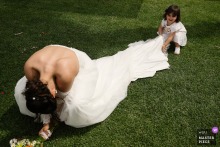   The bride enjoys a lighthearted and joyful moment with her daughter at a reception venue in Lisbon, Portugal, highlighting their special bond during the wedding festivities.