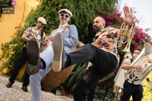  At a reception venue in Lisbon, Portugal, the groom takes to the dance floor with the band, immersing himself in the music and sharing festive energy with the guests.