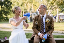   At Ferme d'En Chon, the bride and groom embrace fun and playfulness by enthusiastically playing with bubble guns, creating a lighthearted atmosphere at their wedding celebration.