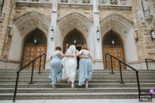 At the Ohio ceremony location, the bride is helped up the stairs, and the small act of guidance gives the arrival a gentle dignity before the vows begin.