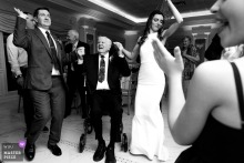 Inside The English Manor in Ocean Township, New Jersey, the bride and groom dance with her grandfather, folding generations into one tender, slightly formal circle of motion.