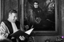 In Amsterdam, A Painting’s Man Seems To Judge The Ceremony Speaker From Above A man in a painting appears to judge the ceremony speaker in Amsterdam, and the joke between art and ritual gives the whole scene a sly, amused edge.