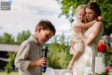 At Domaine de la Clé des Champs in Anché, Poitou Charentes, France, the bride cries during her young son’s speech, her face carrying the ache and pride of family memory.