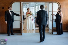 At the Queen Mary in Long Beach, California, the bride arrives from a restaurant to see her fiancé before the ceremony, the setting adding maritime glamour to an intimate reunion.