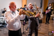 At Riverview at Occoquan, the groom on bass, his father on trumpet, and his uncle on sax slide into the band’s song, turning family into rhythm section.