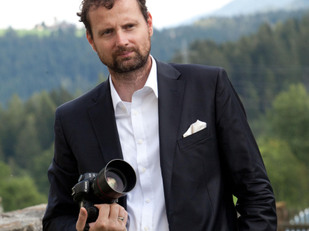 Marek Valovic, wedding photojournalist, posing for a professional portrait outdoors in Vienna, Austria.