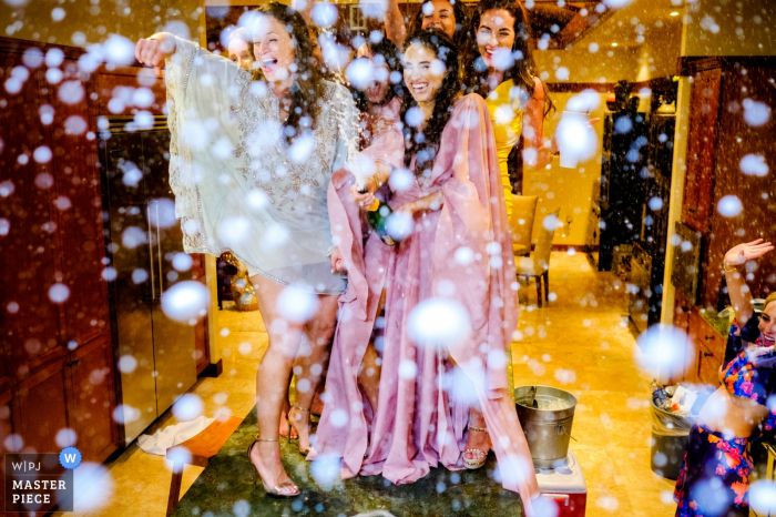 Photo by: <a href="https://www.wpja.com/contests/2016-q4-photography-competition/toastingspeeches/1943061">Ben Chrisman - United States</a> Photo of the bridal party giving a toast as champagne sprays around them by a Charleston, SC wedding photographer.