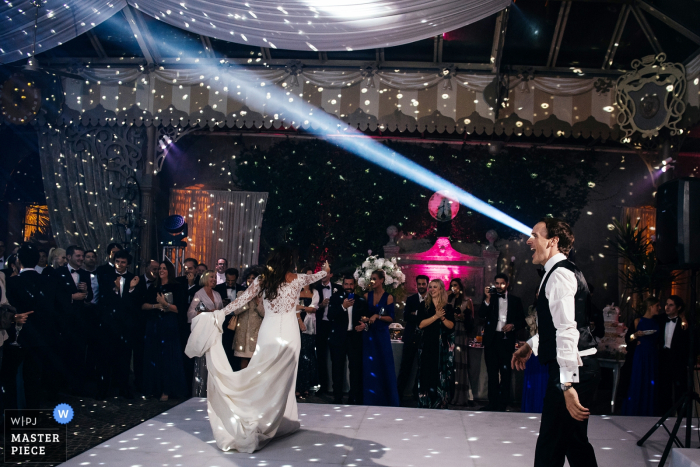 Photo by: <a href="https://www.wpja.com/contests/2016-q4-photography-competition/humor/1970146">Massimiliano Magliacca - Italy</a> Photo of the bride and groom on the dance floor with a spotlight positioned to look like a beam coming from the groom's eye by a Rome wedding photographer.