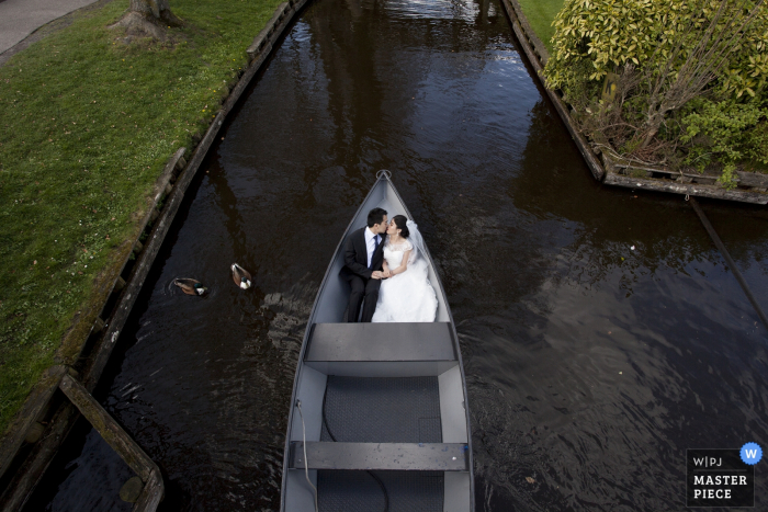 Photo by: <a href="https://www.wpja.com/contests/2017-tri1-photography-competition/wildcard-portrait/1997321">Yishang Hu - Germany</a> North Rhine wedding photographer captured this aerial image of a bride and groom riding in a row boat while ducks swim nearby