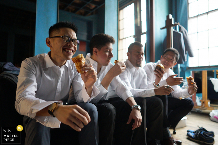 Bronx wedding photographer captured this photo of the groom and his groomsmen enjoying a snack before the ceremony