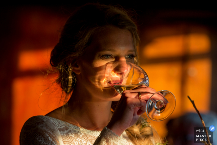 Holland wedding photographer created this image of a bride sipping champagne