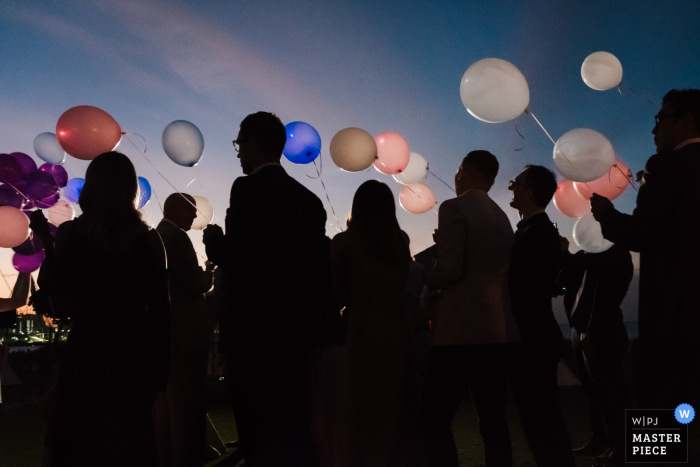 Dubai photo of wedding guests holding balloons outside at sunset Dubai wedding photographer captured this image of wedding guests holding balloons outside at sunset