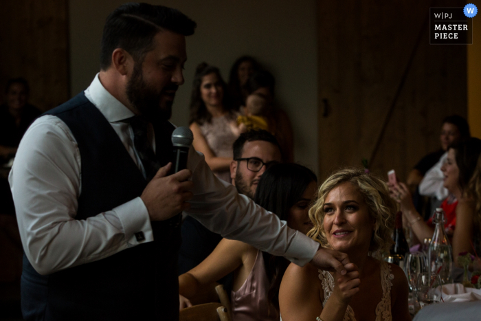 Missoula wedding photographer captured this image of a bride staring lovingly at her groom as he recites his speech at the reception