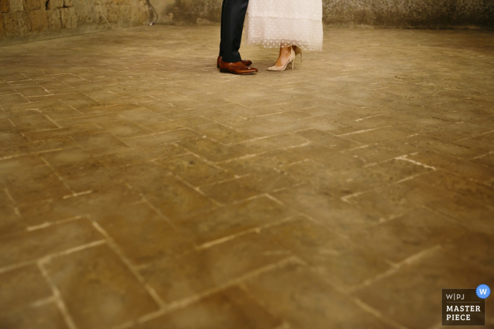 Photo by: <a href="https://www.wpja.com/contests/2017-tri2-photography-competition/minimalism/2044596">Beatrice Moricci - Italy</a> Arezzo wedding photographer captured this detail image of the bride and grooms shoes as they stand toe to toe on a stone floor