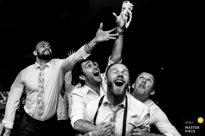 Photo by: <a href="https://www.wpja.com/contests/2017-tri2-photography-competition/bouquetgarter-action/2046296">Luis Efigénio - Portugal</a> A group of enthusiastic men compete to catch the garter in this black and white photo captured by Porto wedding photographer